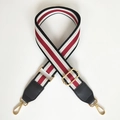 Adjustable woven bag strap featuring red white black stripes and gold metal hardware - Black + Black Leather
