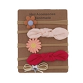 Detail of 5-piece floral bow baby headband set displayed on craft card packaging - Earth Tone Series Style
