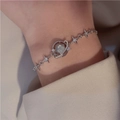 Silver star and planet bracelet with blue stones worn on a female wrist - Silver Planet