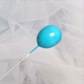 Nahaufnahme hellblauer Luftballon Tortenaufsatz auf weißem Tüll für Geburtstagsfeiern - Blau