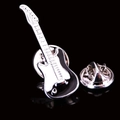 Macro detail of silver and black guitar brooch with textured finish and butterfly clasp - Black White Cello