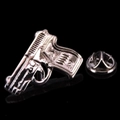 Macro shot of silver pistol lapel pin with mechanical texture and butterfly clutch back - Black Pistol