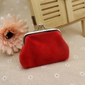 Bright red plush coin purse with silver kiss-lock clasp on a decorative floral background - Red