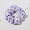 Macro detail of lavender daisy print scrunchie showing fabric texture and pleats - Floral Print Purple