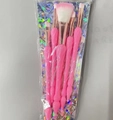 Detail view of 5-piece makeup brush set with pink handles and rose gold tubes in packaging - Pink