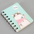 Close-up of A7 spiral notebook featuring a cute blue cartoon cat illustration and binding - Cat-Green