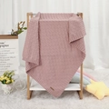 Pink waffle-knit baby blanket in soft solid color on a wooden display stand - 100*80 / Pink
