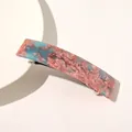 Detail of a pink and blue marble acetate hair clip with a sturdy metal spring clasp - Watermelon red