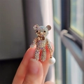 Detailed macro view of gold teddy bear brooch featuring colorful rhinestones and a pearl - XZ0492-1 Colorful Rhinestone