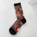 Detailed view of colorful patchwork pattern and knit textures on mid-calf cotton socks - One Size / Brown