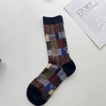 Detail of vintage patchwork crew socks featuring geometric knit patterns in navy and burgundy - One Size / Black