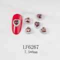 Detail of 7.5x8mm heart-shaped nail rhinestones with silver border on red manicure - Pink Purple Heart Silver Base (6267)