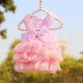 Detailed view of a pink striped pet dress with a mesh tutu and elegant bow decoration - Striped Pink