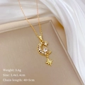 Detail view of gold crescent moon and star pendant with crystal pave on a silk backdrop - Moon Star Style Gold (C306)