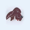 Detailed close-up of a brown enamel dog head brooch with a shiny silver metal border - 3-Dark Brown Setter