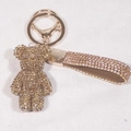 Detail of champagne gold rhinestone teddy bear keychain with matching woven crystal wrist strap - Gold
