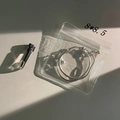 Detailed view of silver bell bracelet in a transparent anti-oxidation storage pouch - Thin Style / Small Square