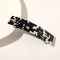 Detailed view of the black and white tortoise shell pattern on a rectangular hair claw clip - Black and White