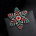 Snowflake brooch with red and green rhinestones for festive outfits and holiday styling - Snowflake