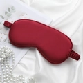 Elegant red silk sleep mask with elastic strap and pearl accessories on white satin background - Wine Red Eye Mask
