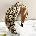 Close-up of leopard print wide headband with twist knot design and woven texture - Leopard Beige