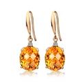 Élégantes boucles d'oreilles pendantes dorées avec gemme orange ovale et diamants - Boucles d'oreilles