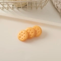 Detailed view of three resin biscuit-shaped hair charms on a cream decorative tray - Plain Biscuit-Round