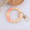 Detail of cream and pink silicone bead keychain with 3D rose and gold lobster clasp - Nude Floral