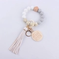 Detail of beaded keychain with leopard silicone beads, white tassel and MAMA engraved disc - White