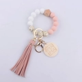 Close-up of silicone beads, pink tassel, and wooden MAMA tag on the wristlet keychain - Light Pink