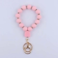 Dettaglio portachiavi con perle in silicone rosa e moschettone in metallo dorato - Rosa