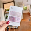 Detail von rosa glitzernden und holografischen rechteckigen Haarklammern auf Karte - Rosa