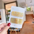 Detailaufnahme von Glitzer-Haarspangen-Set mit goldenem Metallic-Finish auf Karte - Gelb