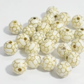 Detailed macro view of white soccer ball acrylic beads with golden lines for jewelry making - 10mm Football White Background Gold Line