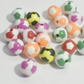 Detailed view of colorful soccer-shaped acrylic beads with pre-drilled holes for DIY jewelry - 8mm Football Mixed Color Blocks