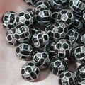 Detailed view of silver and black football pattern acrylic beads for jewelry making - 10mm Football Black Background Silver Line