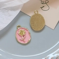 Detailed view of alloy rose charms with pink enamel, faux pearls, and golden metal back - 5# Pink