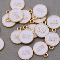 Macro shot of white enamel circular BFF charms with gold plating for DIY jewelry - White