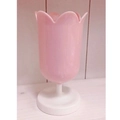 Detail showing the tulip-shaped pink desktop organizer with a white base and petal edges - Pink