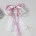 Close-up of pink and cream bow hair clip with pearls, rhinestones and long satin ribbons - Korean Pink and Beige