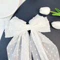 Detail of white chiffon oversized bow hair clip with textured polka dots and long ribbons - White