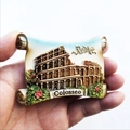 Close-up of a resin Rome Colosseum souvenir fridge magnet with hand holding it - Colosseum Scroll