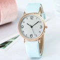 Close-up of a slim rose gold quartz watch featuring a light blue leather strap and white dial - Light Blue