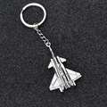 Silver fighter jet metal aircraft keychain on a professional black sparkling background - GX- J-20 Budget Version