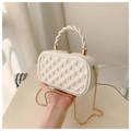 Detailed shot of white quilted hardshell bag with gold chain and twisted handle - Off-white