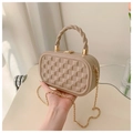 Close-up of beige quilted crossbody bag with twisted top handle and gold chain strap - Khaki