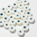 Macro shot of 10mm white evil eye polymer clay spacer beads for DIY jewelry making - White