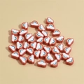 Detailed macro view of mixed colorful rainbow cloud loose beads for DIY handmade jewelry - Red