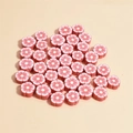 Macro detail of mixed color 10mm plum blossom polymer clay beads for DIY jewelry making - Red