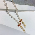 Detail of crystal eyewear chain featuring a red zircon bow and gold lobster clasp - Red Bow